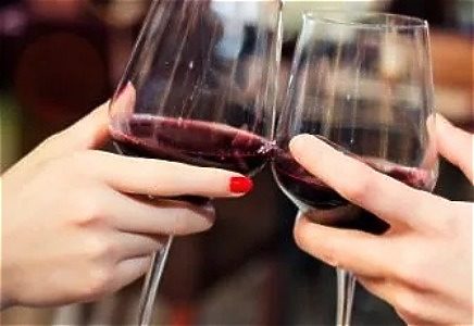 Two glasses of wine being held