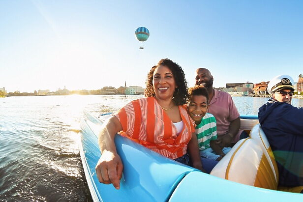 girl holding a stuffed minnie mouse in front of World of Disney store