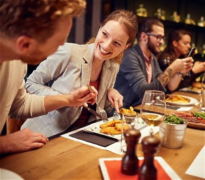 Friends eating together at a large table