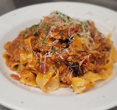 Pasta dish with meat sauce and grated cheese