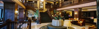 Hotel Julien Dubuque lobby with elegant wooden furnishings and grand staircase