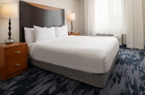hotel room with one queen bed