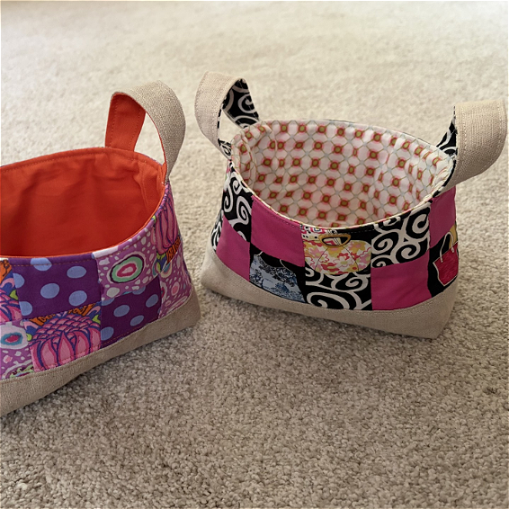 two baskets made of pieced together fabric