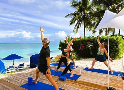 Group of people doing yoga on a beach