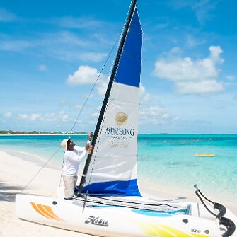 Man adjusting sail on boat