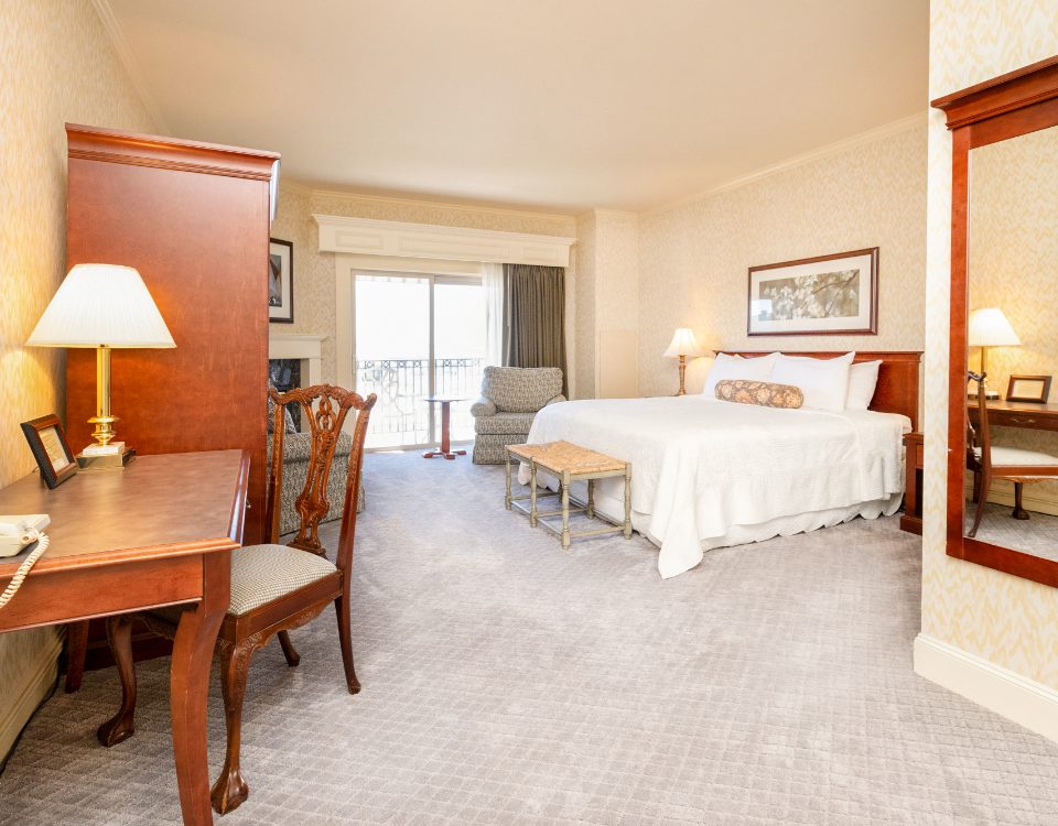 a hotel room with a bed and desk