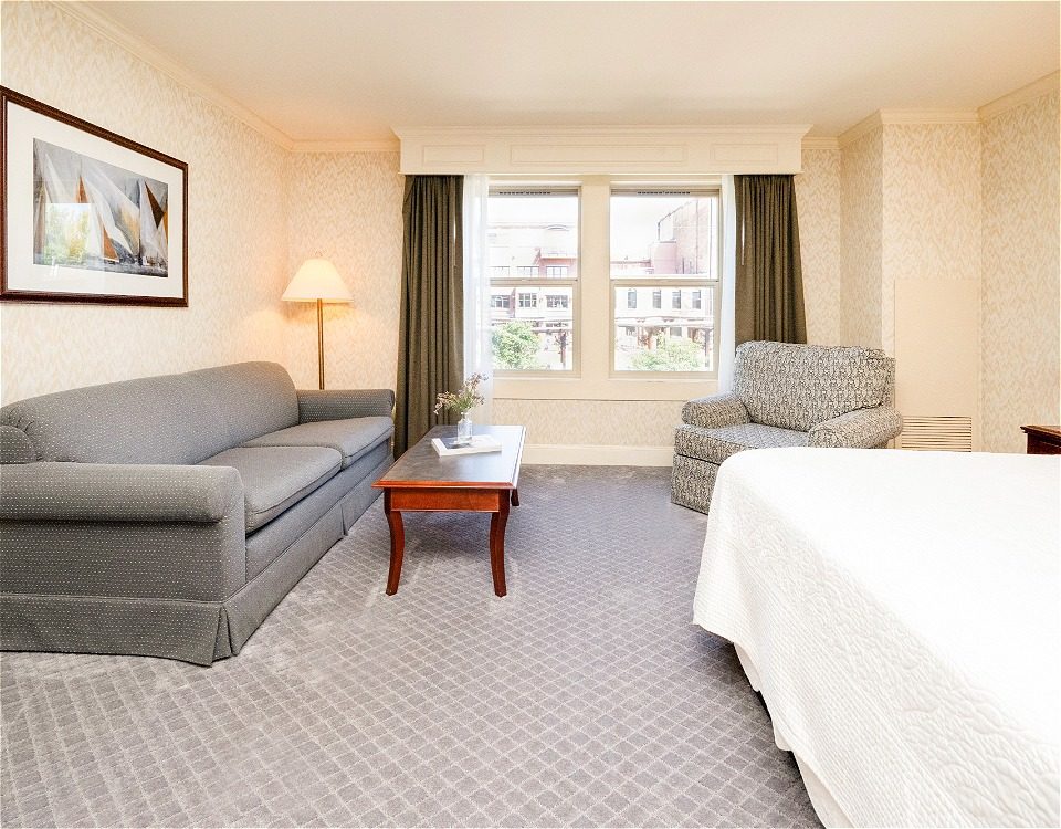 hotel room with a bed and sofa