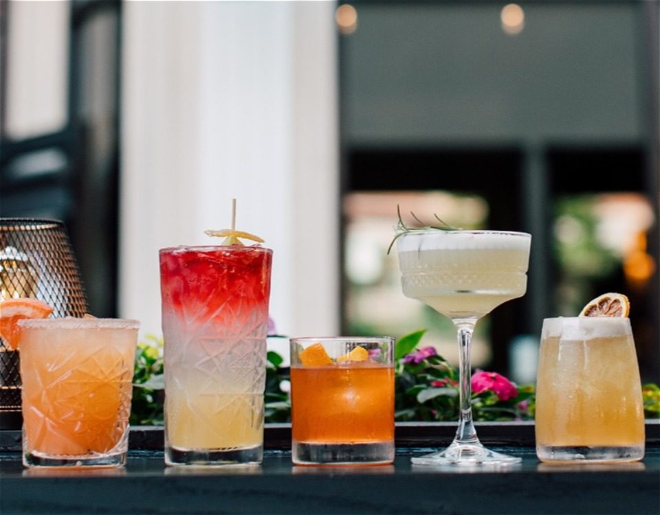 Flight of colorful cocktail drinks