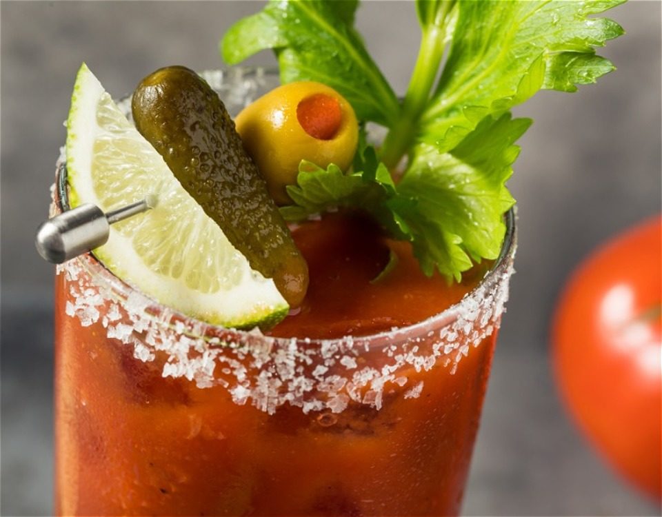 Bloody mary with salted rim glass, lime, pickle, olive, and celery