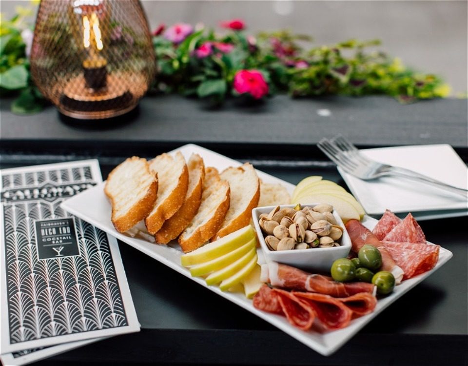 Charcuterie plate with bread, cheese, and other items
