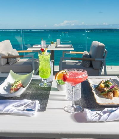 Couple dining on the beach at Beachfront at Windsong