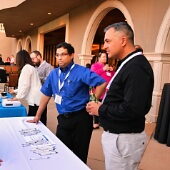 Team members standing at table small