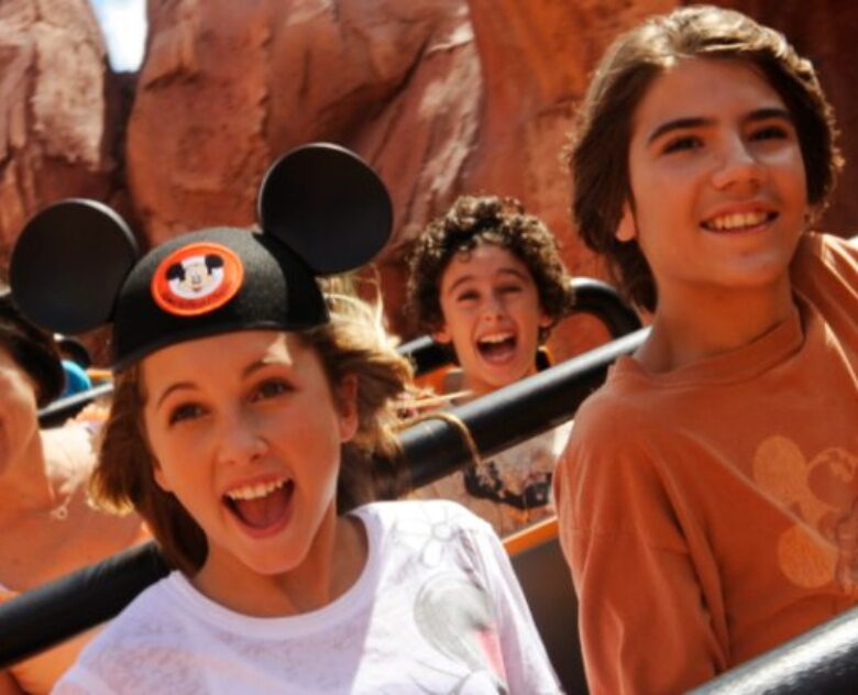 Two kids riding a roller coaster