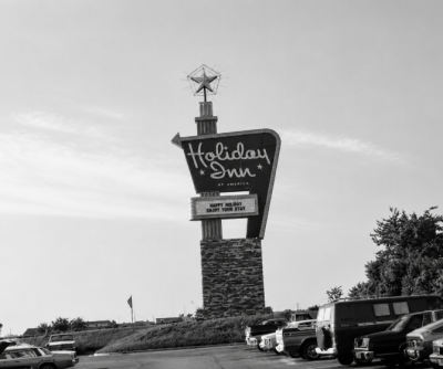 Old photo of people standing in front of a Holiday Inn