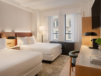 Aura Hotel room bed with lamp